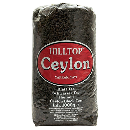 A large, clear plastic bag (1000g) of Hilltop Ceylon Black Leaf Tea (Yaprak Çayı / Blatt Tee) with a prominent red and black oval label.
