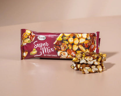 Packaged Granio Super Mix bar ("Der reine Genuss"), a gluten-free and vegan-friendly snack bar featuring visible pieces of nuts and fruit.