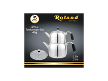 Ein glänzendes Roland Deutschland Riva Edelstahl-Doppel-Teekannen-Set (4-teiliges Teekannen-Set) mit schwarzen Griffen und Glasdeckel.