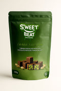 A dark green S'weet Beat pouch (120g) of Turkish Chocolate Pistachio Delight (Lokum), featuring square pieces of chocolate-covered pistachio Turkish delight.